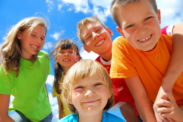 eine Gruppe Kinder die lachen und in die Camera schauen